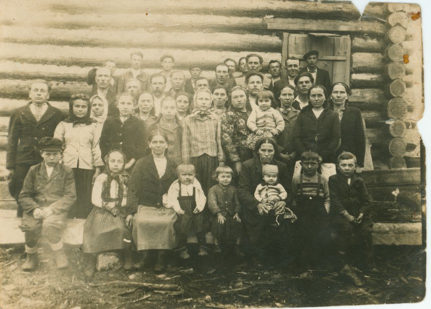 Exiles from the Ukrainian SSR gathered near a barracks. Up to six families could live in a single room. They slept on bunks and took turns cooking on a stove in the middle. Dunayka settlement, Irkutsk Region. 1951.